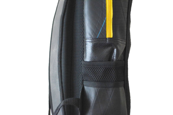 Fair trade, eco friendly, vegan backpack viewed from the side showing side pockets and the yellow zip
