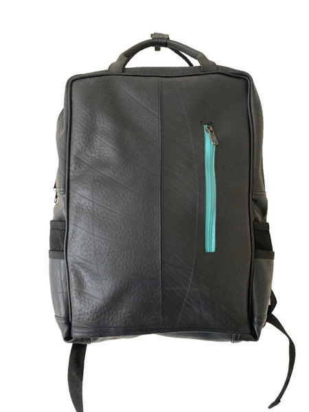 Fair trade, eco friendly, vegan backpack viewed from the front. The main body is made from black inner tubes that show tyre patterning and textures. There is a front zip pocket with vibrant mint green fabric around the zip and a black hanging strap