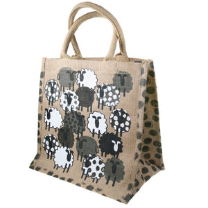 Fair trade eco-friendly jute bag in natural colour with a pattern of screen printed white, black and grey sheep