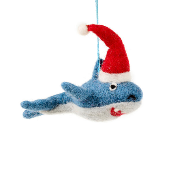 Blue felt shark decoration wearing a red Santa hat with a toothy grin